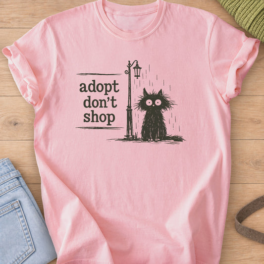 Scruffy black cat sitting in the rain by a street lamp, "adopt don't shop", dark charcoal ink on a Blossom T-Shirt