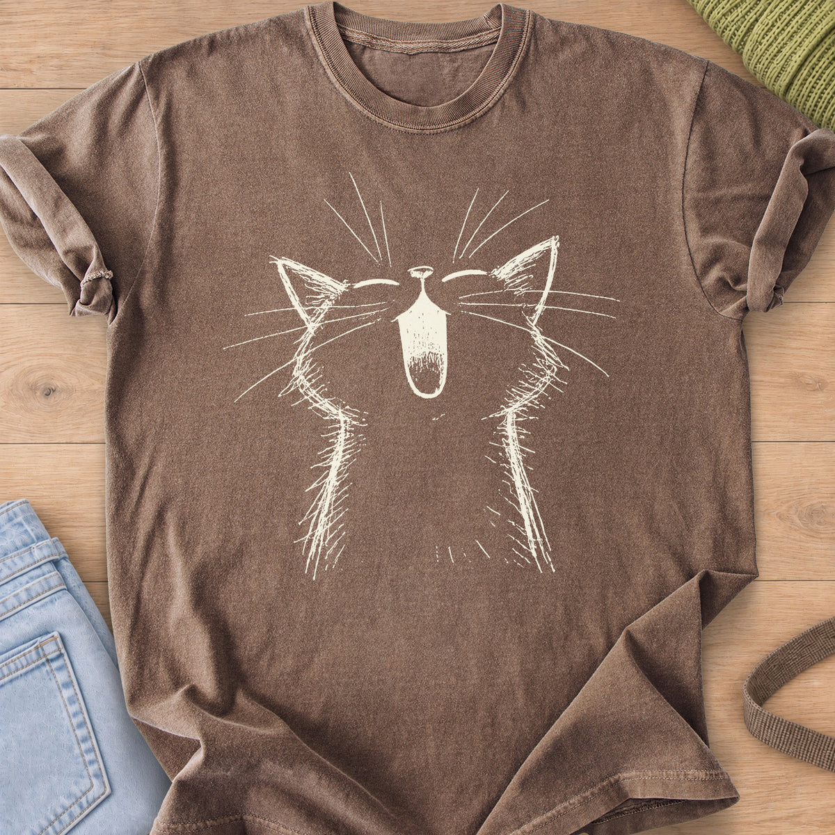 Cat with eyes shut and mouth wide open in a big meow, long whiskers fanning out, cream ink on an Espresso T-Shirt