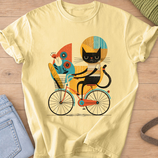 Black cat riding a bicycle with a baguette and flowers in its front basket on a Butter T-Shirt
