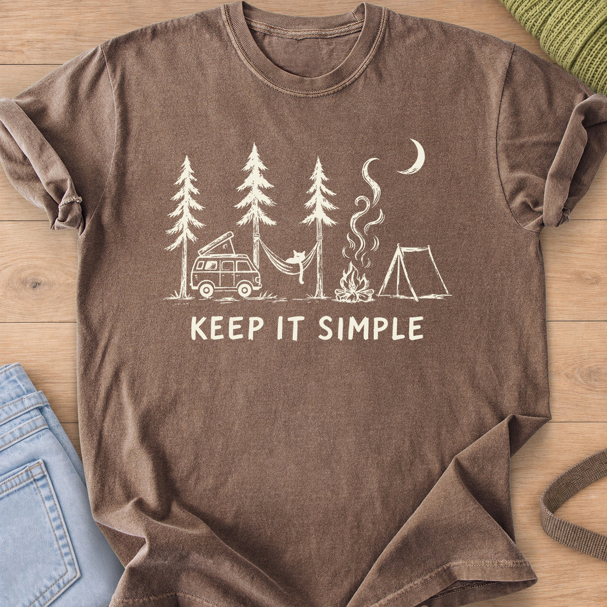 Cat in a hammock between pines with camper van, campfire, tent and "KEEP IT SIMPLE", cream ink on an Espresso T-Shirt