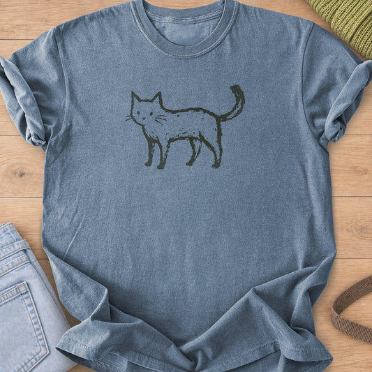 Rough hand-drawn cat standing sideways with its tail up, looking out, dark charcoal ink on a Blue Jean T-Shirt