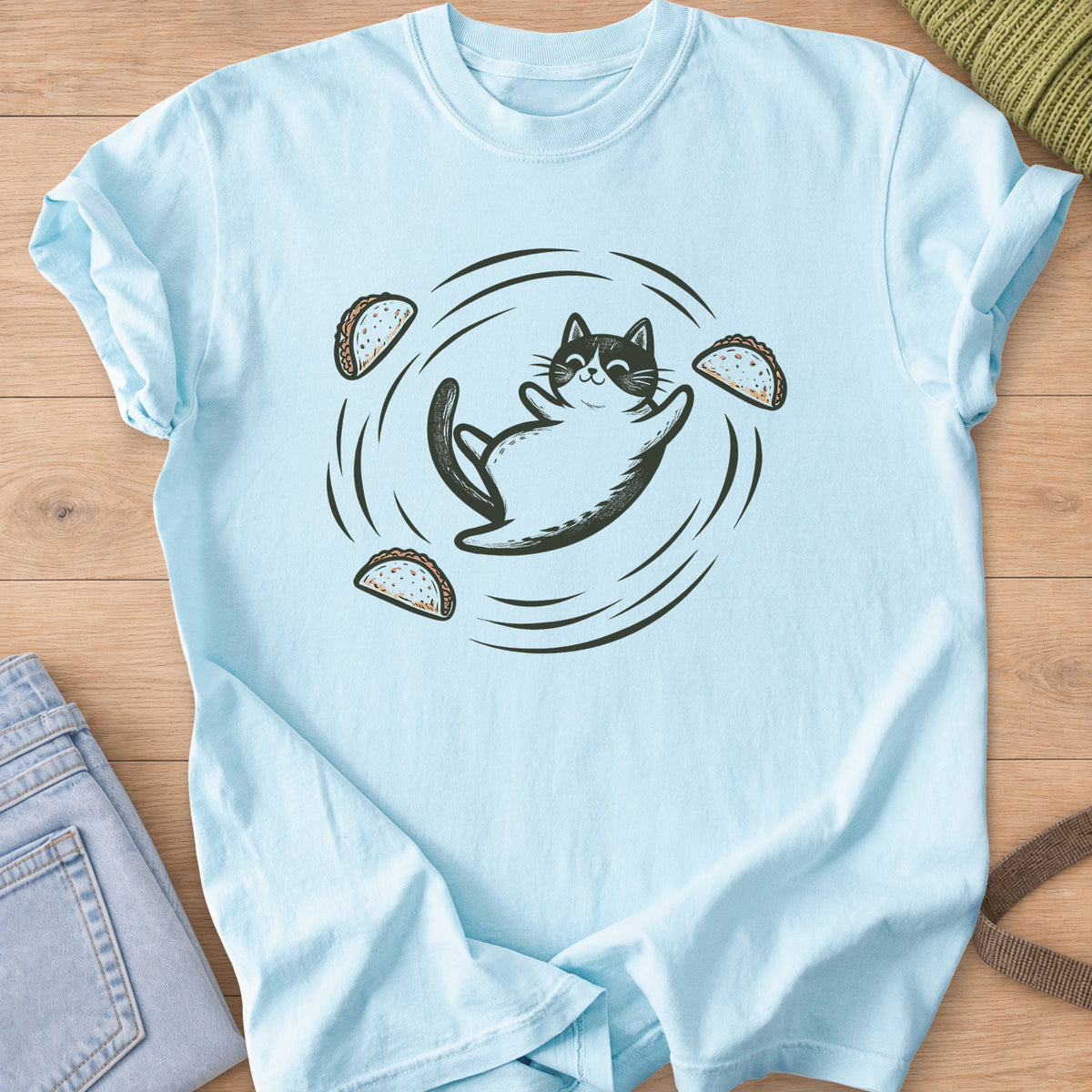 Smiling tuxedo cat rolling on its back as tacos swirl around it on a Chambray T-Shirt