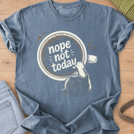 Cat from behind reaching a paw into a coffee cup that reads "nope not today", cream ink on a Blue Jean T-Shirt