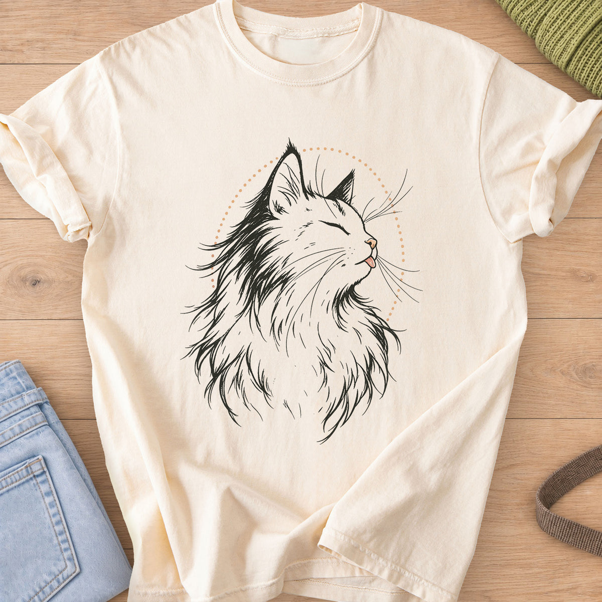 Fluffy cat, eyes closed, tiny tongue out, framed by a dotted arc, black and tan ink on an Ivory T-Shirt