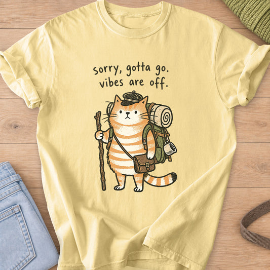 Tabby cat hiker with backpack and walking stick, "sorry, gotta go. vibes are off." on a Butter T-Shirt