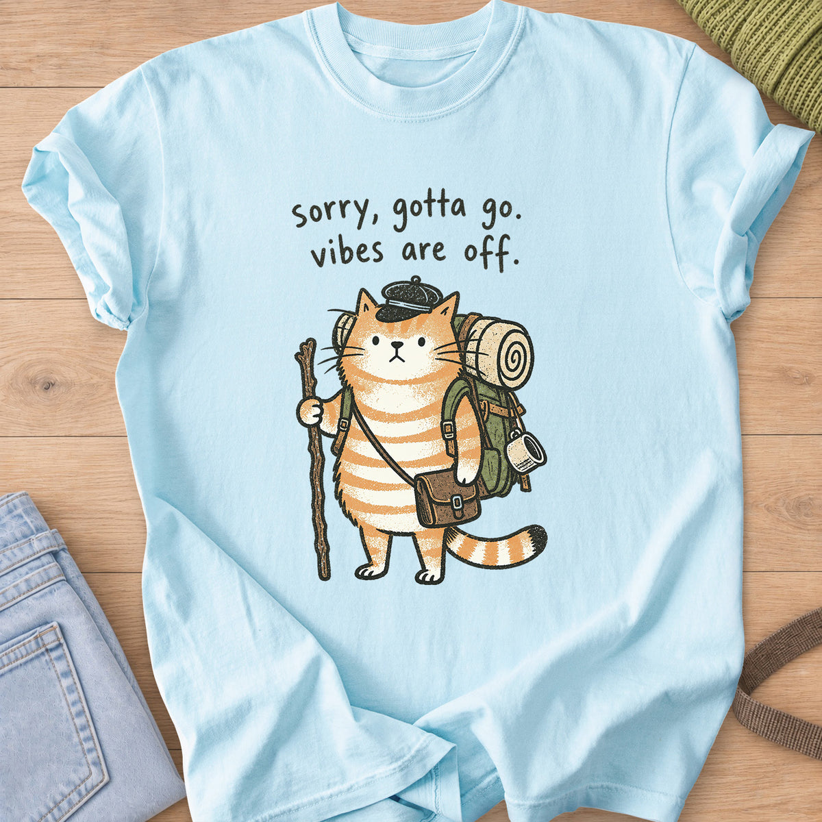 Tabby cat hiker with backpack and walking stick, "sorry, gotta go. vibes are off." on a Chambray T-Shirt