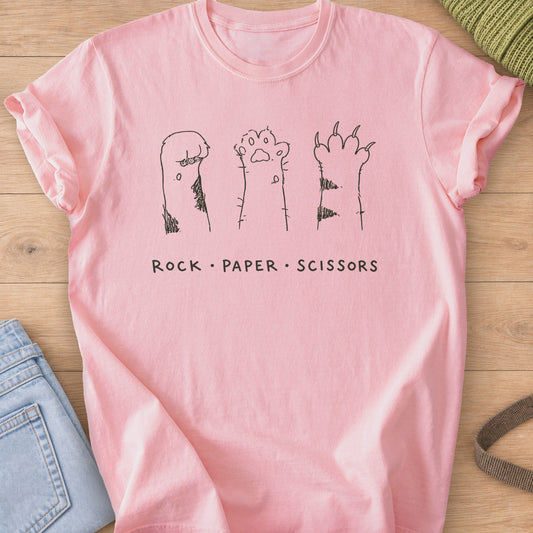 Three raised cat paws, curled, open and clawed, above "Rock Paper Scissors", dark charcoal ink on a Blossom T-Shirt