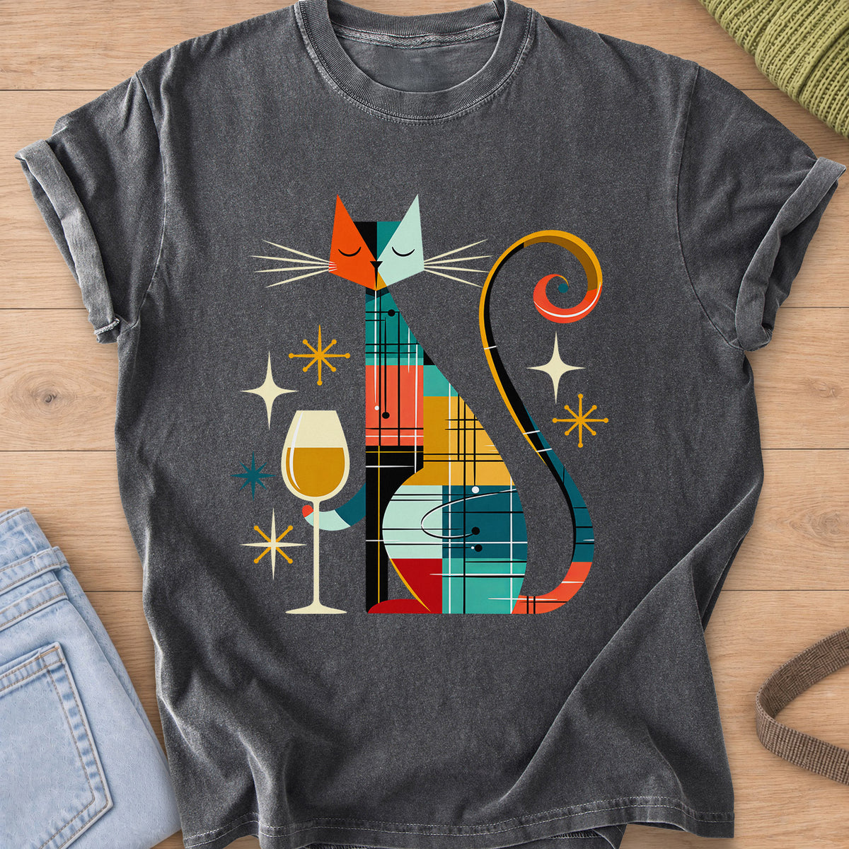 Geometric patchwork cat with closed eyes holding a wine glass among starbursts on a Pepper T-Shirt