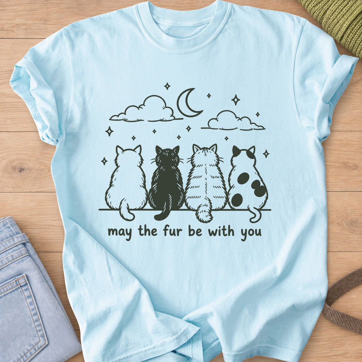 Four cats from behind gaze at a crescent moon and stars, "may the fur be with you", dark charcoal ink on a Chambray T-Shirt
