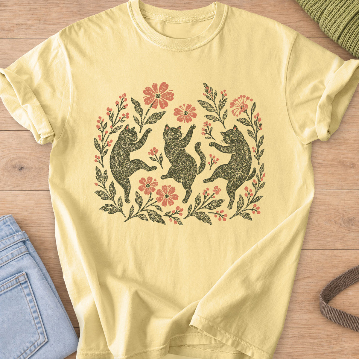 Three cats dancing on their hind legs among flowers, leafy stems and berries, charcoal and coral ink on a Butter T-Shirt