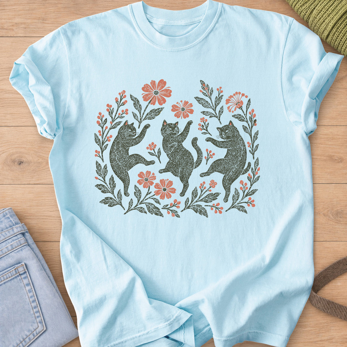 Three cats dancing on their hind legs among flowers, leafy stems and berries, charcoal and coral ink on a Chambray T-Shirt