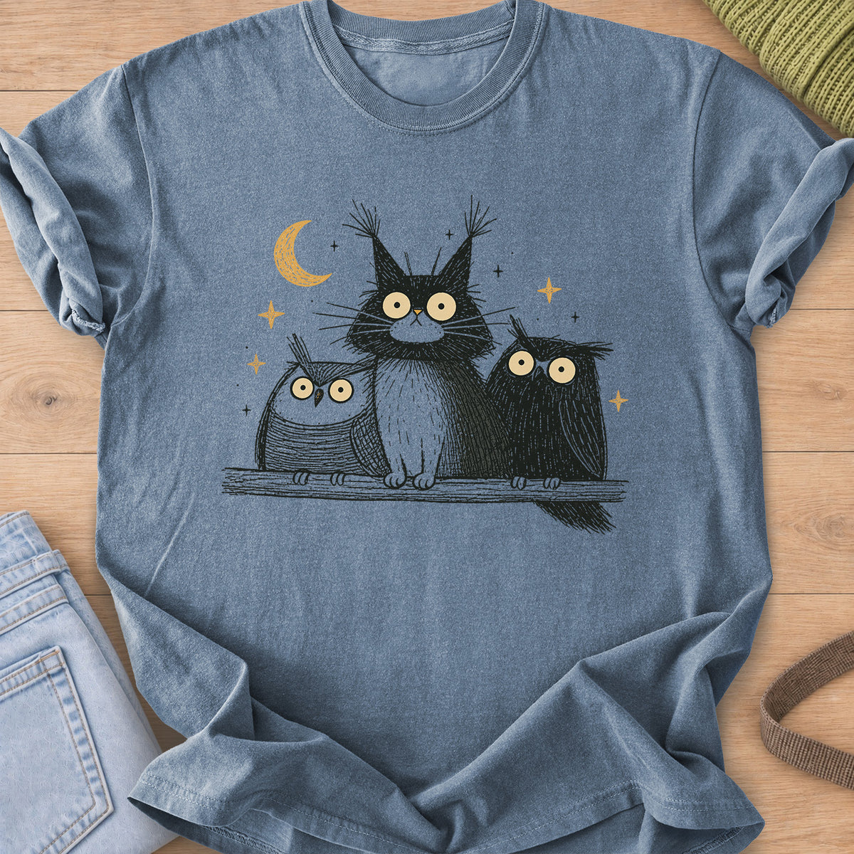 Wide-eyed fluffy cat on a branch between two owls under a crescent moon and stars on a Blue Jean T-Shirt