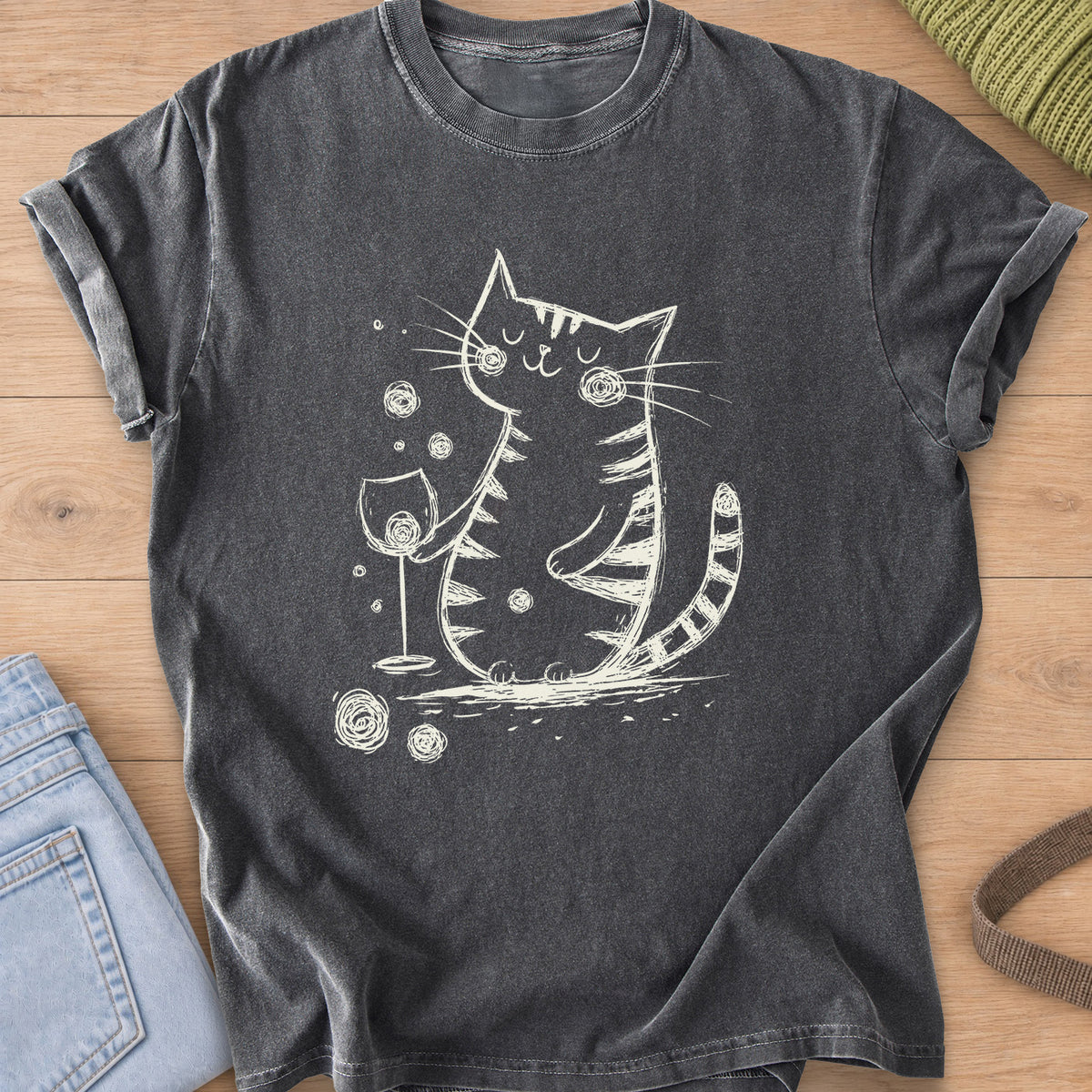 Content tabby cat with eyes closed holding a wine glass, scribbled swirls around it, cream ink on a Pepper T-Shirt