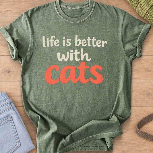Rounded script reading "life is better with cats" with "cats" in large letters, cream and coral ink on a Moss T-Shirt