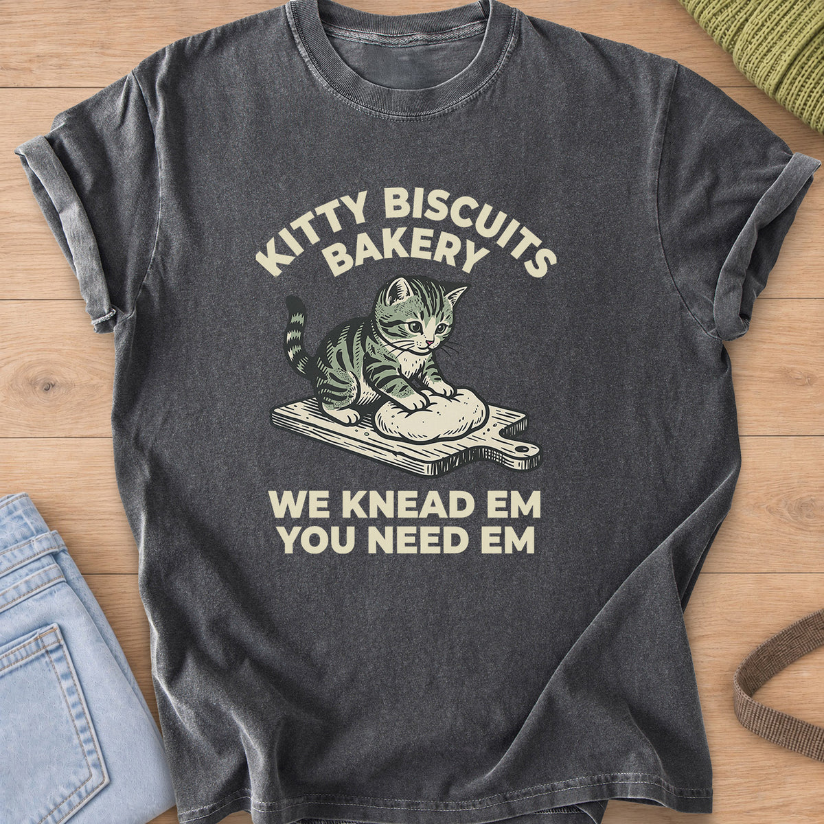 Tabby kitten kneading dough on a cutting board under "Kitty Biscuits Bakery" on a Pepper T-Shirt