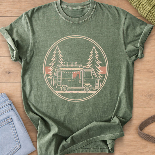 Cat sitting in a camper van window under string lights, framed by pine trees, cream ink on a Moss T-Shirt