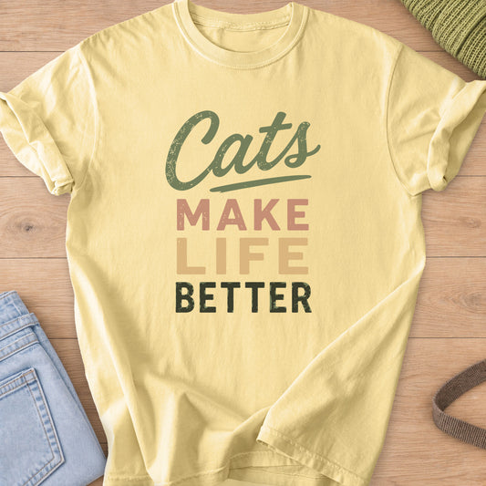 Distressed text reading "Cats Make Life Better" with a script swash under "Cats" on a Butter T-Shirt