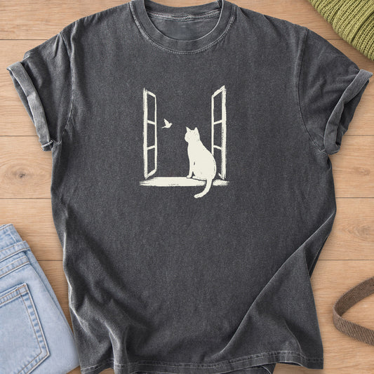 Cat sitting on the sill of an open window, watching a small bird fly past, cream ink on a Pepper T-Shirt