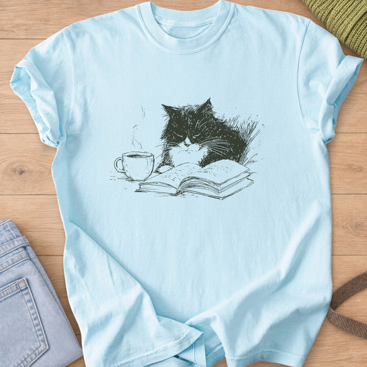 Fluffy tuxedo cat dozing over an open book beside a steaming coffee cup, dark charcoal ink on a Chambray T-Shirt