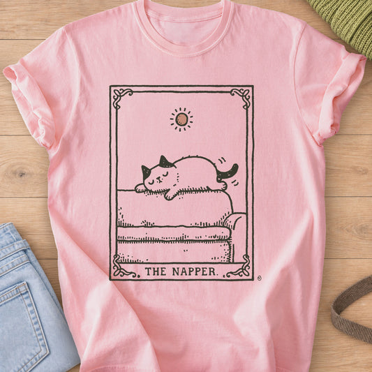 Tarot-style card of a cat napping on a sofa under a small sun, "THE NAPPER.", dark charcoal ink on a Blossom T-Shirt