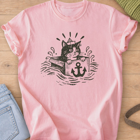 Cat in a paper boat hat peeking from a box with an anchor, floating on waves, dark charcoal ink on a Blossom T-Shirt