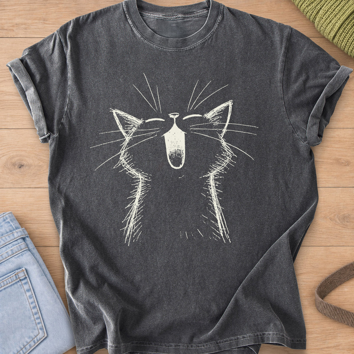 Cat with eyes shut and mouth wide open in a big meow, long whiskers fanning out, cream ink on a Pepper T-Shirt