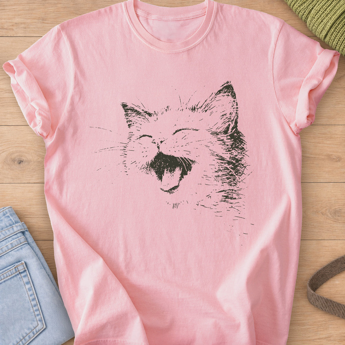 Cat laughing with eyes squeezed shut, mouth wide open and long whiskers, dark charcoal ink on a Blossom T-Shirt
