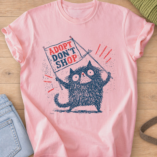 Scruffy wide-eyed cat holding a protest flag that reads "ADOPT DON'T SHOP", navy and red ink on a Blossom T-Shirt