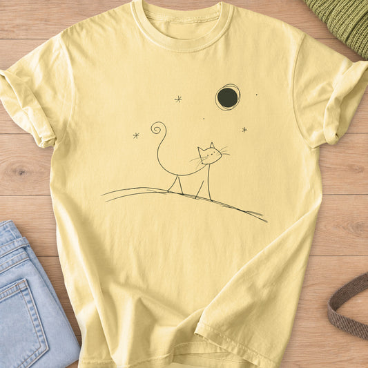 Thin doodle cat with a curly tail walking along a hill under the moon and stars, dark charcoal ink on a Butter T-Shirt