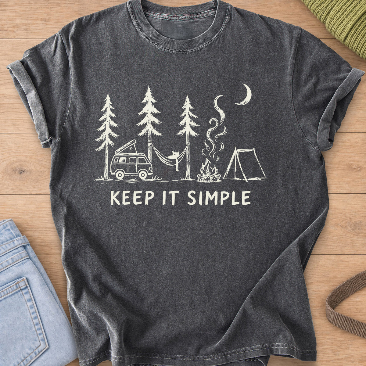 Cat in a hammock between pines with camper van, campfire, tent and "KEEP IT SIMPLE", cream ink on a Pepper T-Shirt