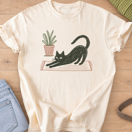 Black cat in a long stretch on a striped rug beside a potted plant on an Ivory T-Shirt