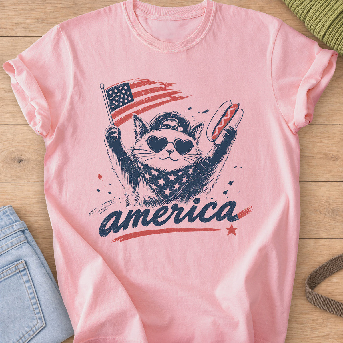 Cat in heart sunglasses and a cap holding a flag and a hot dog above "america", navy and red ink on a Blossom T-Shirt