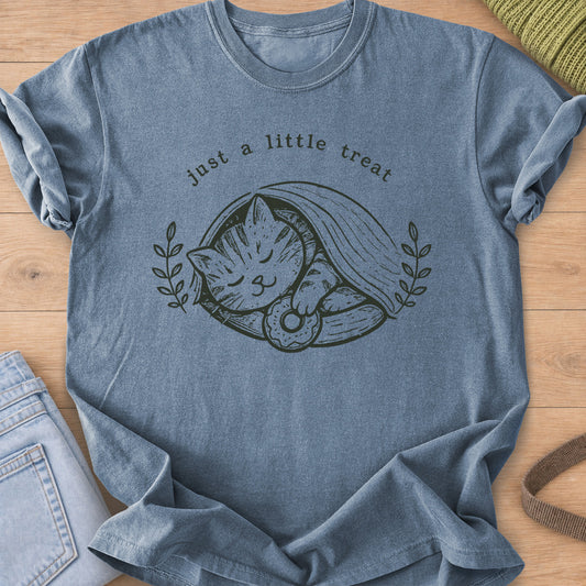 Tabby cat asleep under a blanket holding a donut, framed by laurel sprigs, dark charcoal ink on a Blue Jean T-Shirt