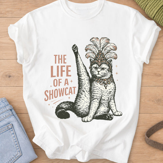 Cat in a feathered showgirl headdress raises one leg high, "The Life of a Showcat" on a White T-Shirt