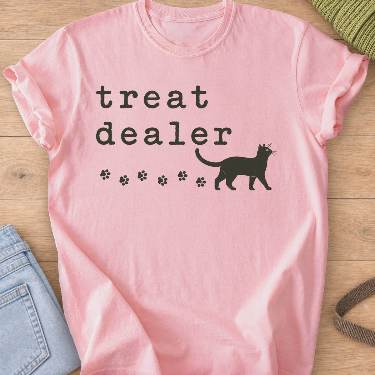 Walking cat silhouette with a trail of paw prints beneath the words "treat dealer", dark charcoal ink on a Blossom T-Shirt