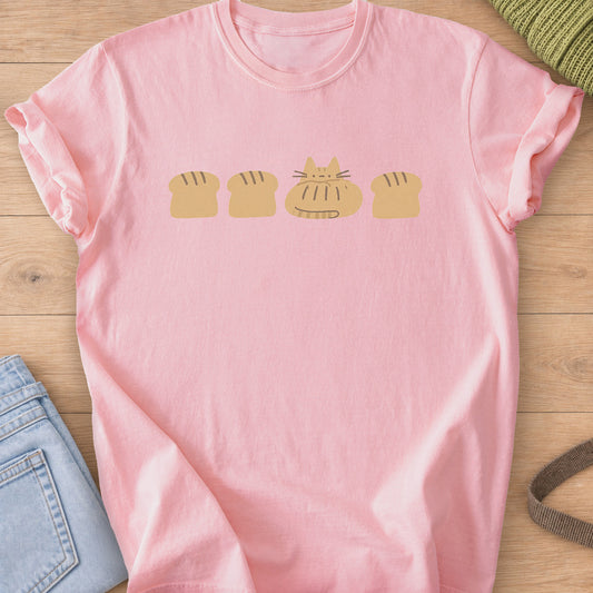 Tabby cat loaf tucked into a row of bread loaves with scored tops, mustard ink on a Blossom T-Shirt