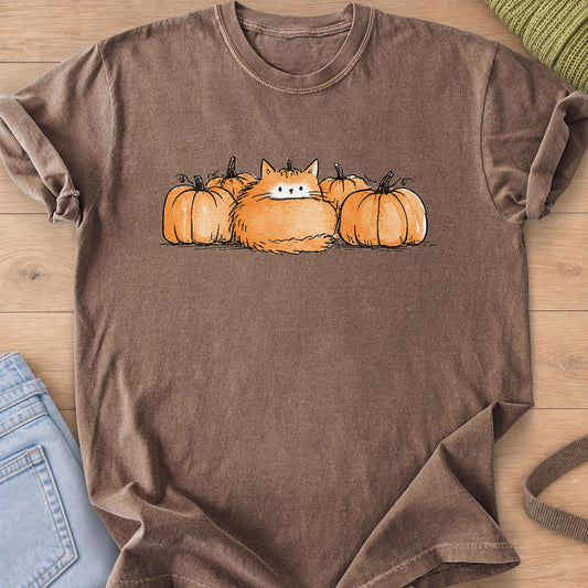 Fluffy round cat sitting in a row of pumpkins, posing as one of them on an Espresso T-Shirt