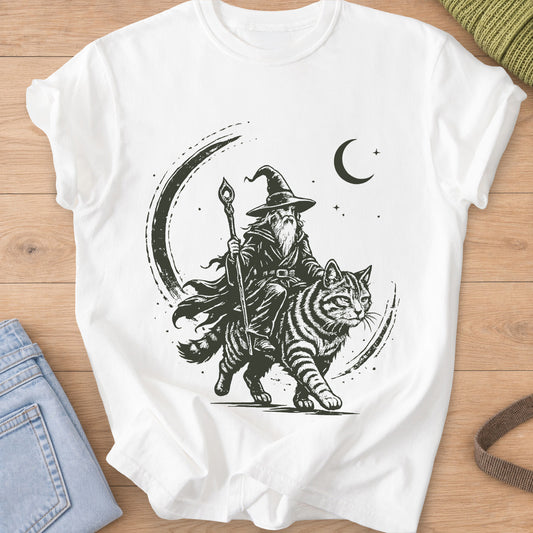 Bearded wizard with a staff riding a big striped cat under a crescent moon, dark charcoal ink on a White T-Shirt