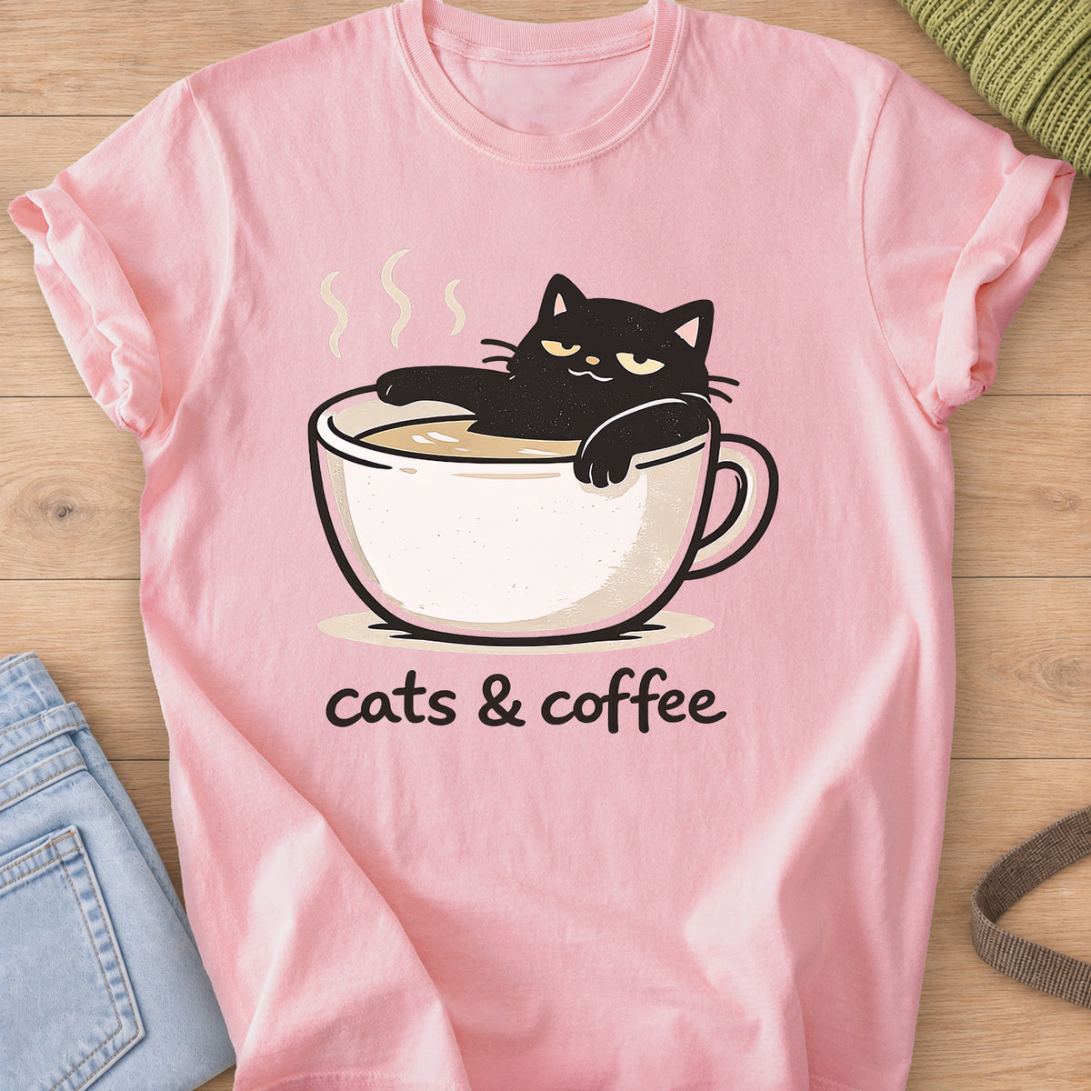Black cat lounging in a steaming coffee cup above the words "cats & coffee" on a Blossom T-Shirt