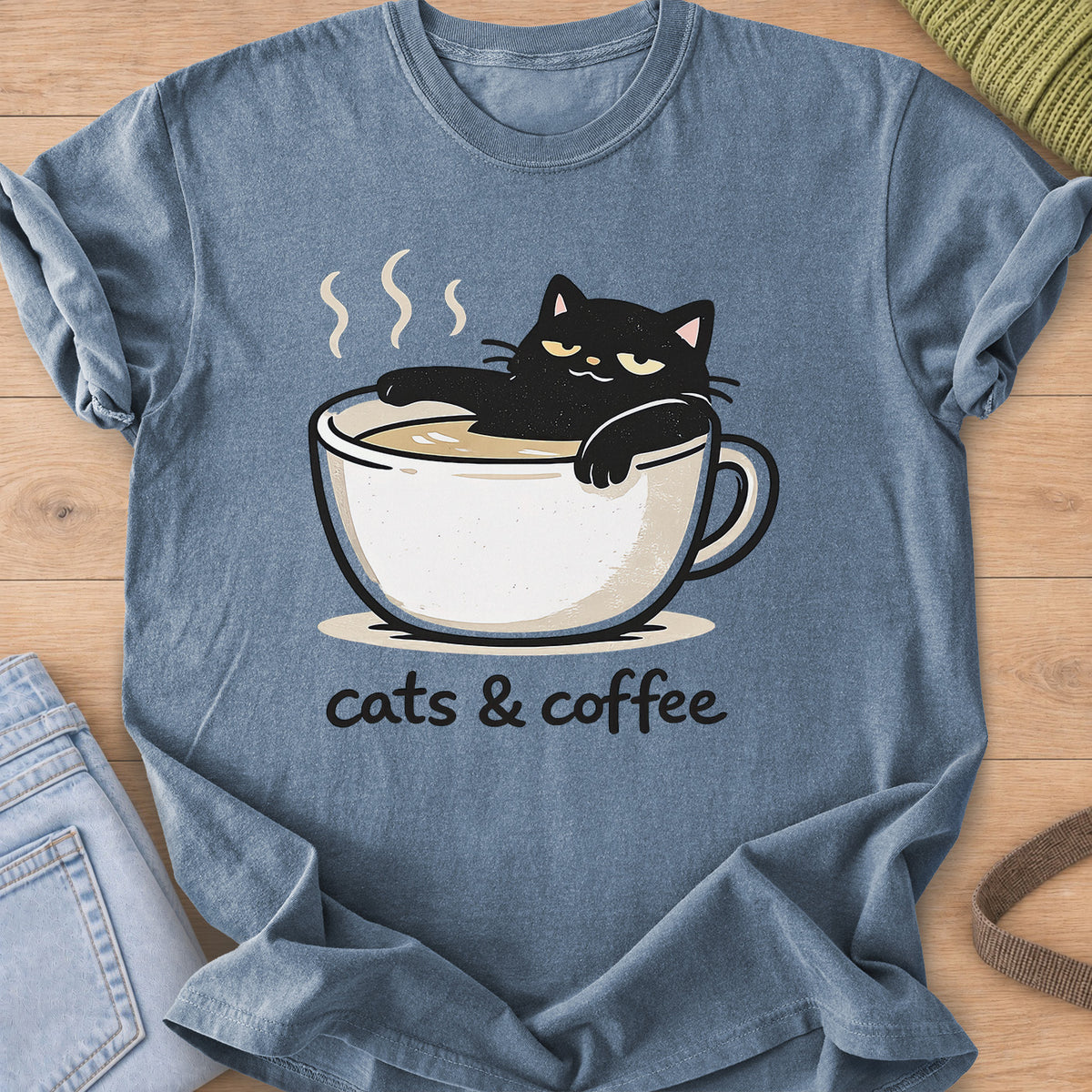Black cat lounging in a steaming coffee cup above the words "cats & coffee" on a Blue Jean T-Shirt