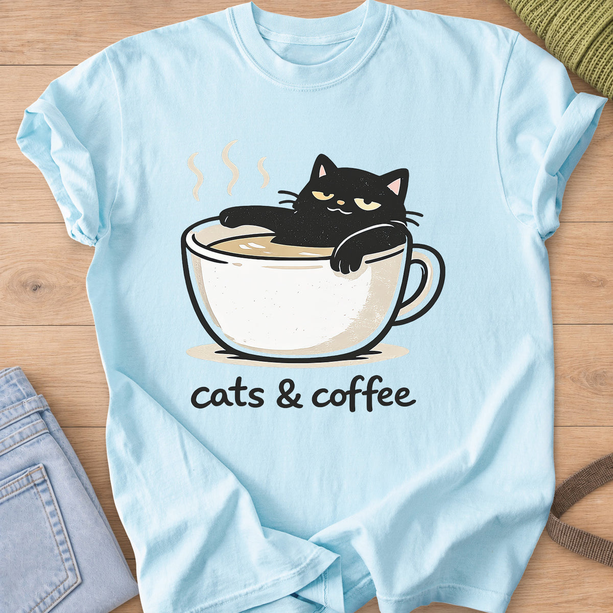 Black cat lounging in a steaming coffee cup above the words "cats & coffee" on a Chambray T-Shirt
