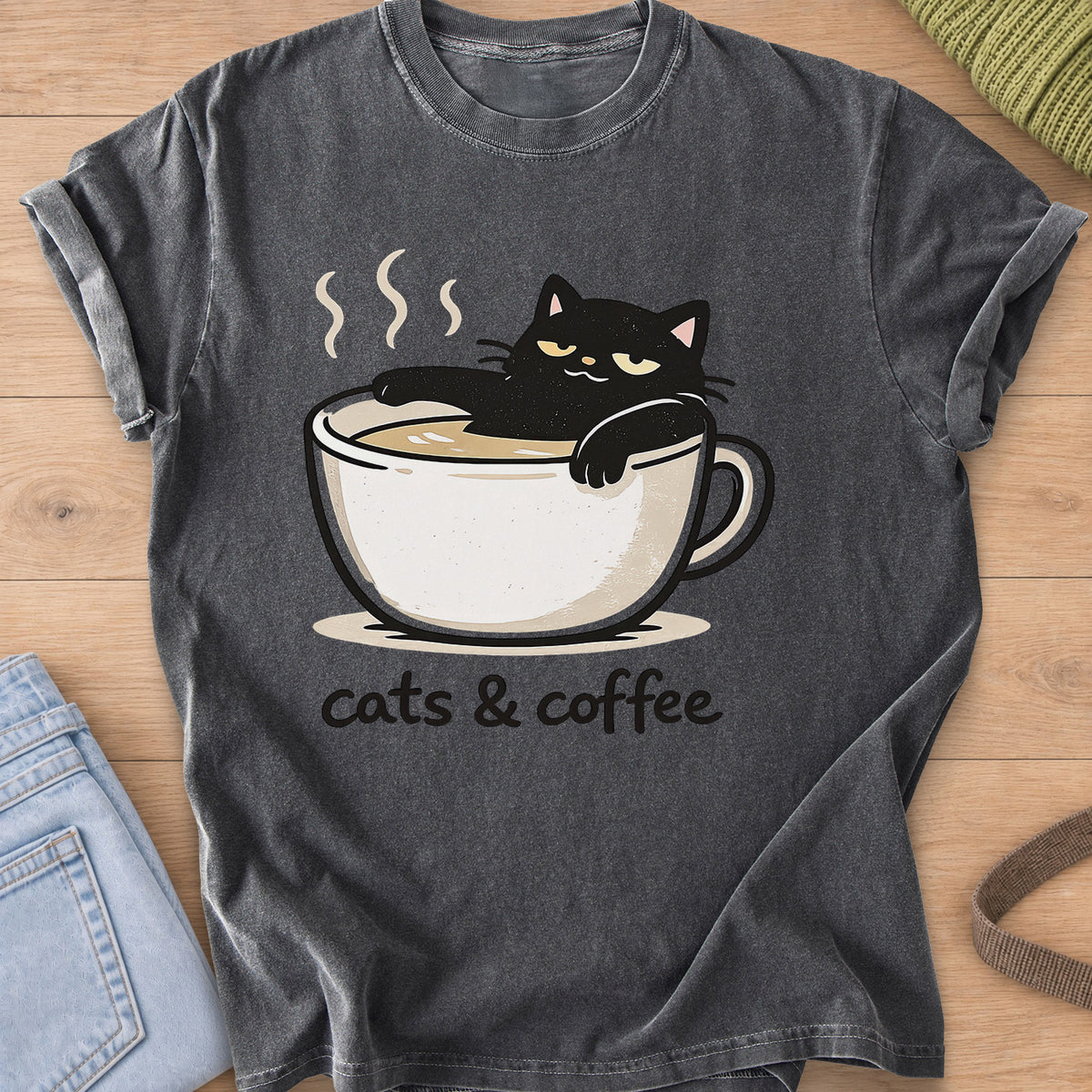 Black cat lounging in a steaming coffee cup above the words "cats & coffee" on a Pepper T-Shirt