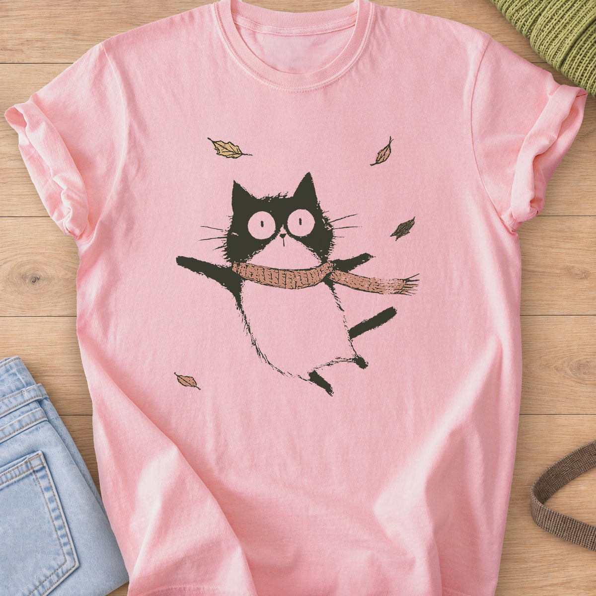 Cat in a knit scarf flying through the air, paws out, among falling autumn leaves on a Blossom T-Shirt