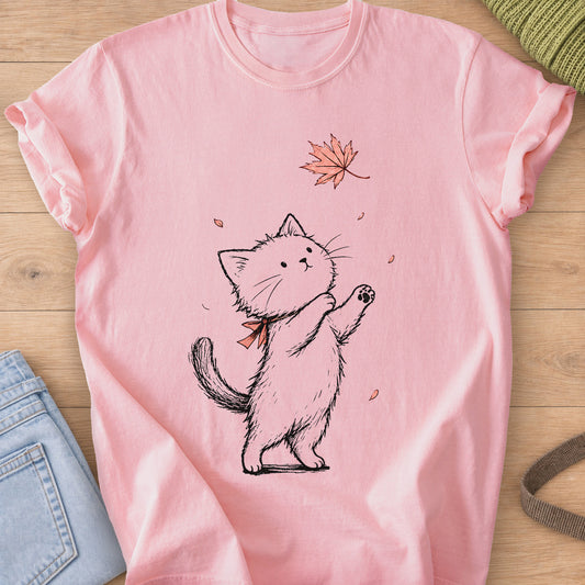 Fluffy cat on hind legs with a neck bow, reaching for a falling maple leaf on a Blossom T-Shirt