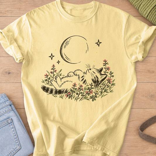 Tabby cat napping on its back in wildflowers under a crescent moon and stars on a Butter T-Shirt