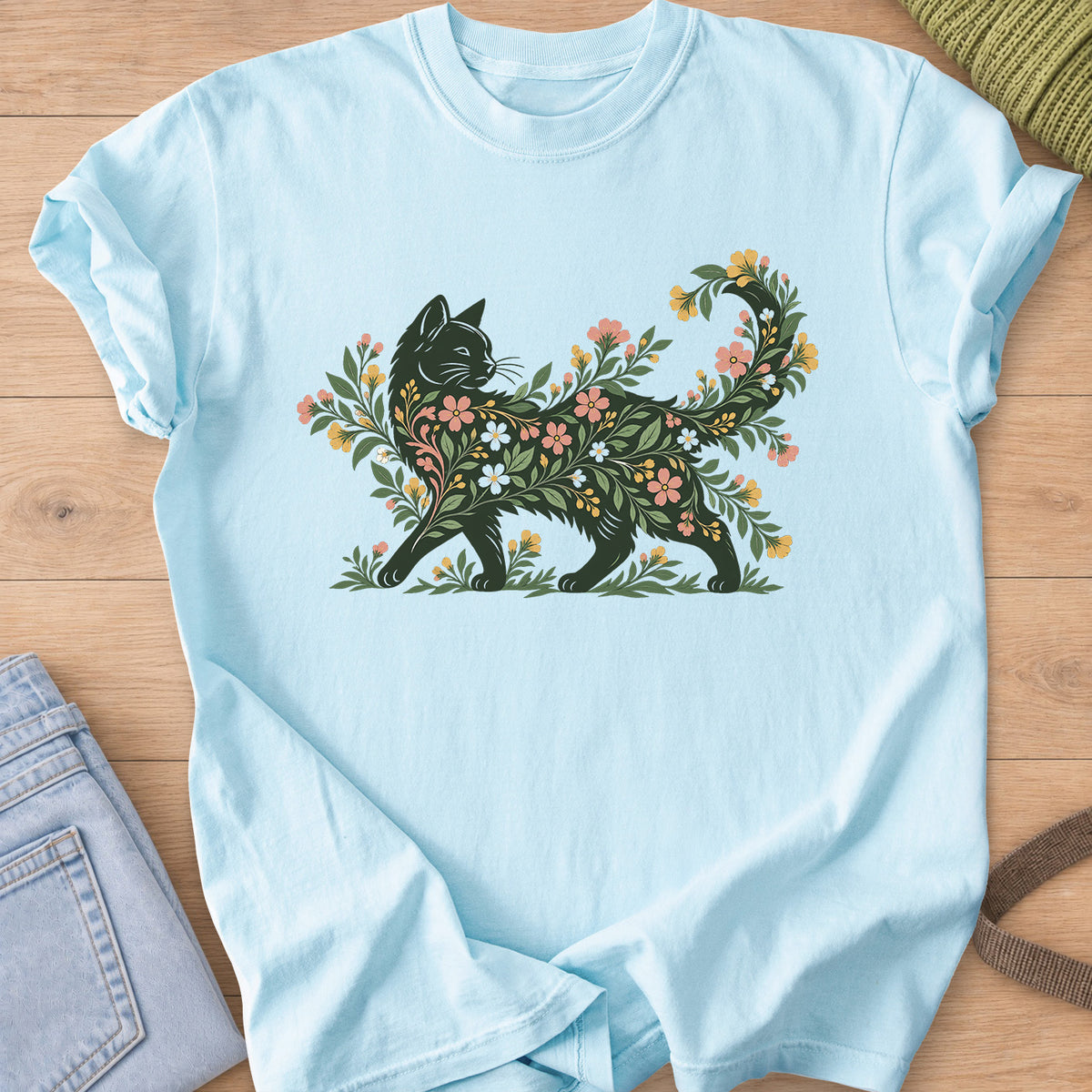 Walking cat silhouette filled with blooming flowers and leafy vines, tail curled up on a Chambray T-Shirt