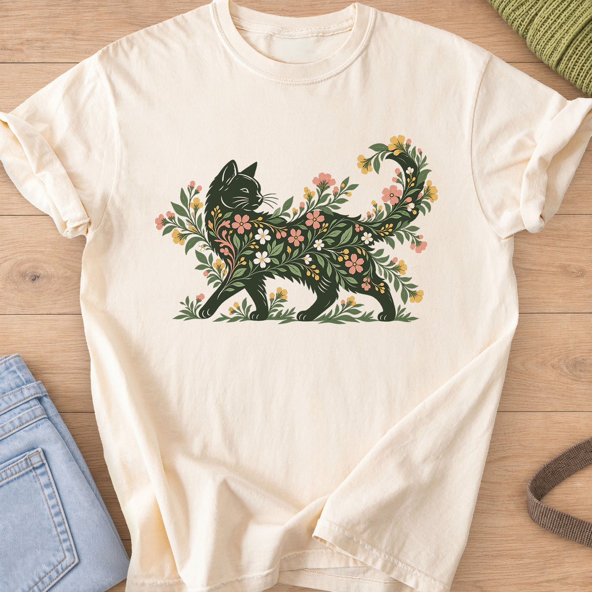 Walking cat silhouette filled with blooming flowers and leafy vines, tail curled up on an Ivory T-Shirt