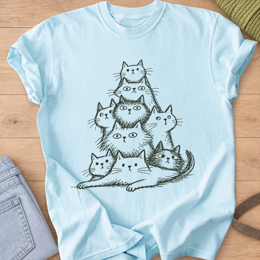 Pyramid of nine wide-eyed fluffy cats stacked up, one lying stretched at the base, dark charcoal ink on a Chambray T-Shirt