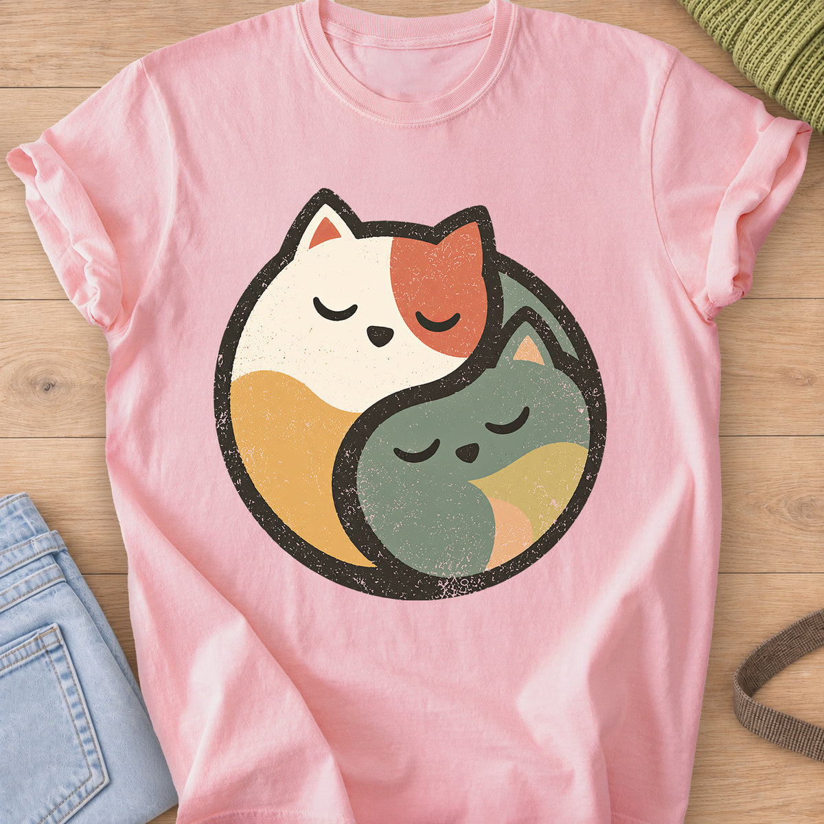 Two sleeping cats curled together to form a round yin yang circle on a Blossom T-Shirt