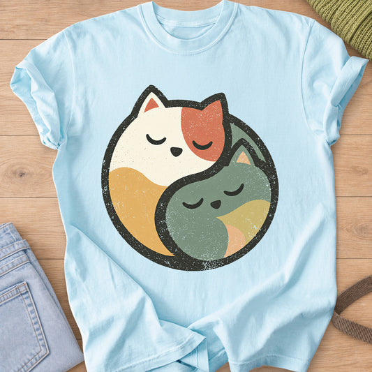 Two sleeping cats curled together to form a round yin yang circle on a Chambray T-Shirt
